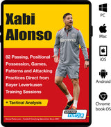 A soccer coach in a gray tracksuit gestures on the field, illustrating Xabi Alonso - 82 Passing, Positional Possession, Games, Patterns, and Attacking Practices Direct from Bayer Leverkusen Training Sessions by SoccerTutor.